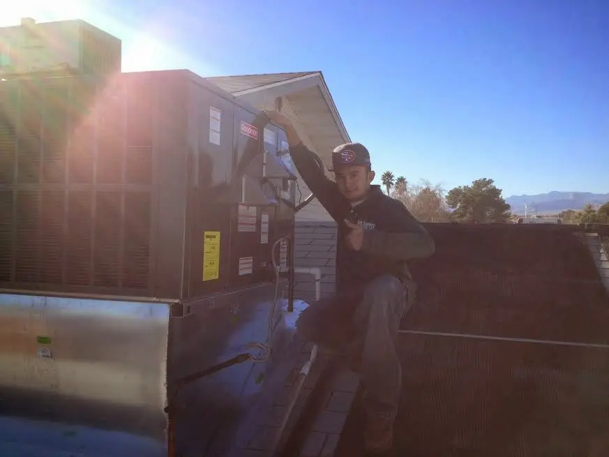 HVAC technician performing HVAC Inspection on a rooftop unit in Glendale
